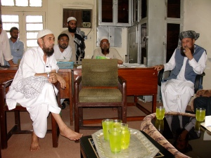 Maulana Sami Ul Haq (right) greets guests