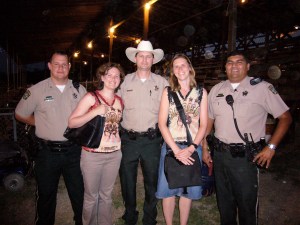 Posing with sheriffs at a rodeo